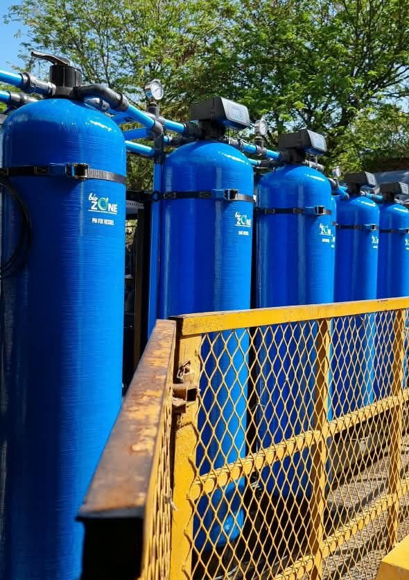 Blue filter vessels mounted on a steel treatment skid for Krugersdorp High School's borehole backup water system